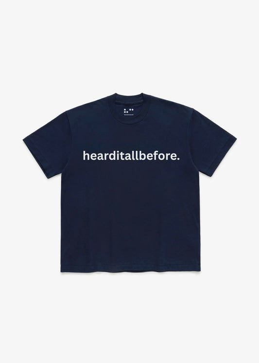 Navy blue t-shirt with 'hearditallbefore.' text on a white background