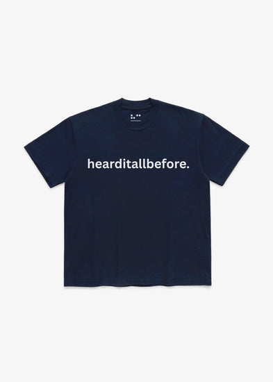 Navy blue t-shirt with 'hearditallbefore.' text on a white background